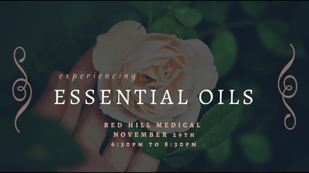 A person holding a rose in front of the text " experiencing essential oils."