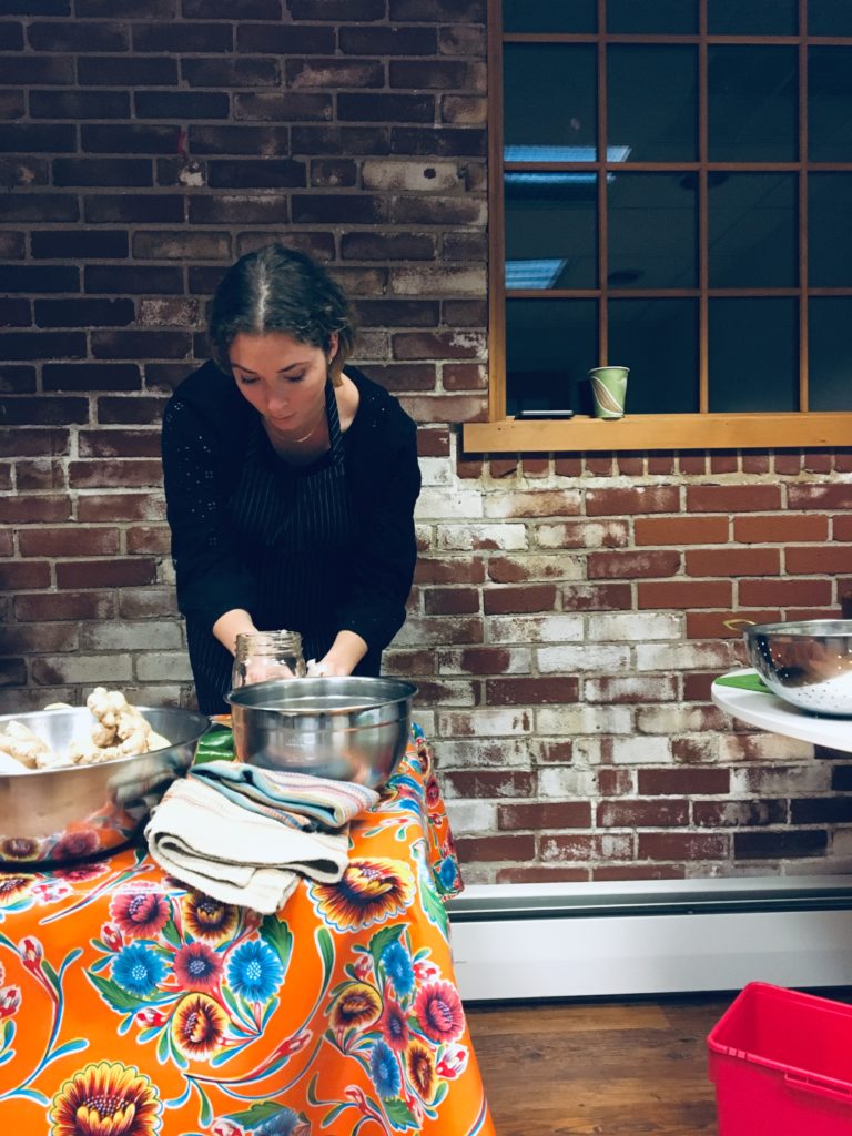 A woman is cooking food on the stove.